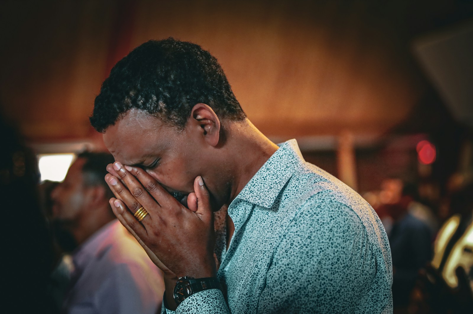 A man is praying with his hands.